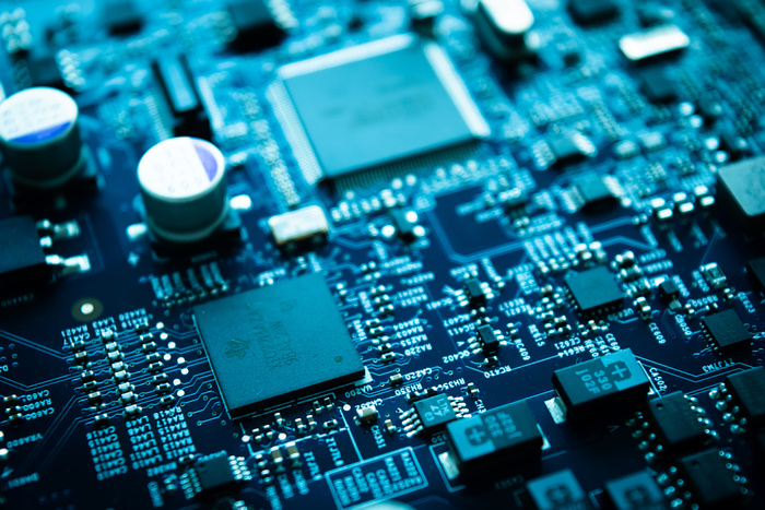 Close-up of a circuit board featuring microchips and electronic components, illustrating the technology involved in electronics restoration services offered by Steamatic of Tampa.